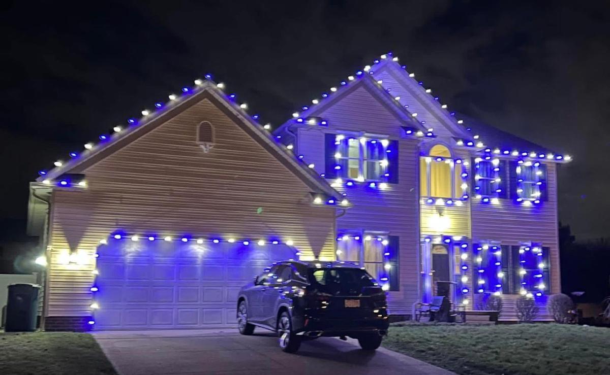 Two-story home with blue and white roofline lights