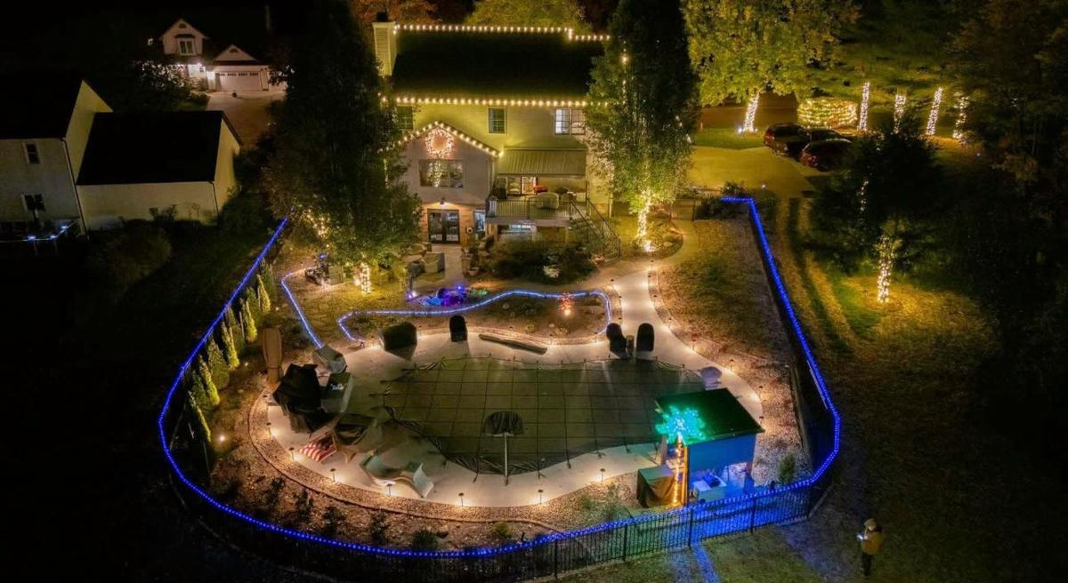 Backyard pool and patio outlined in lights