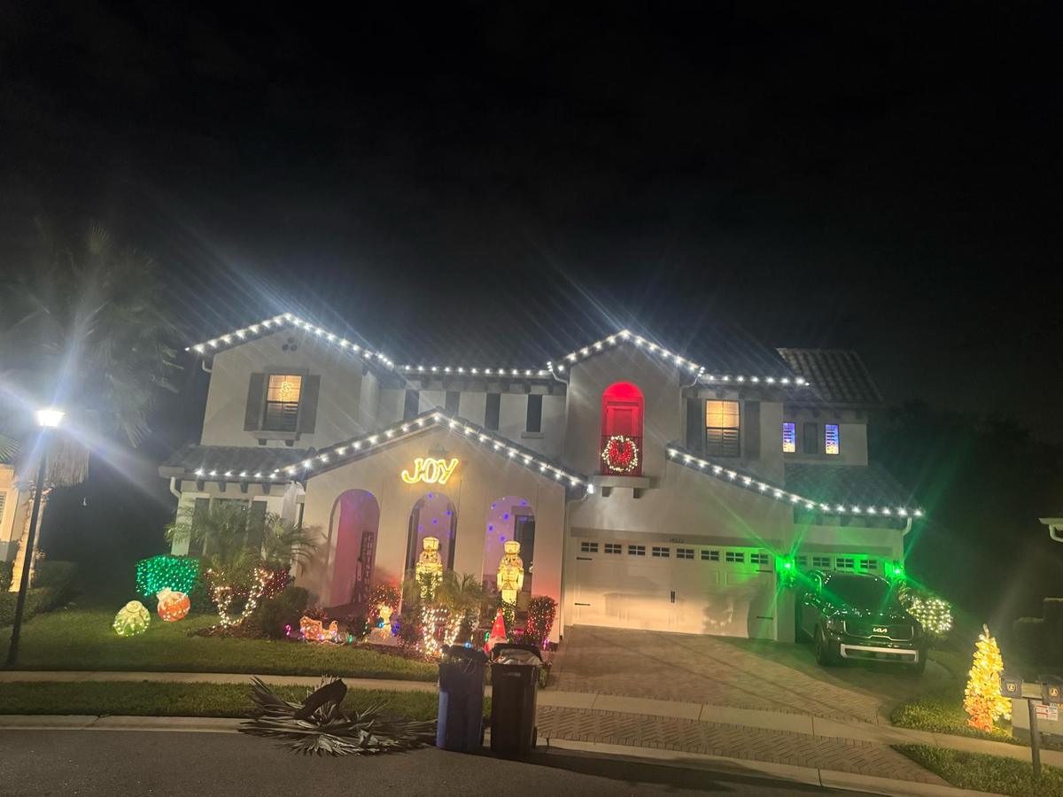 Two-story home with multicolour roofline and yard display