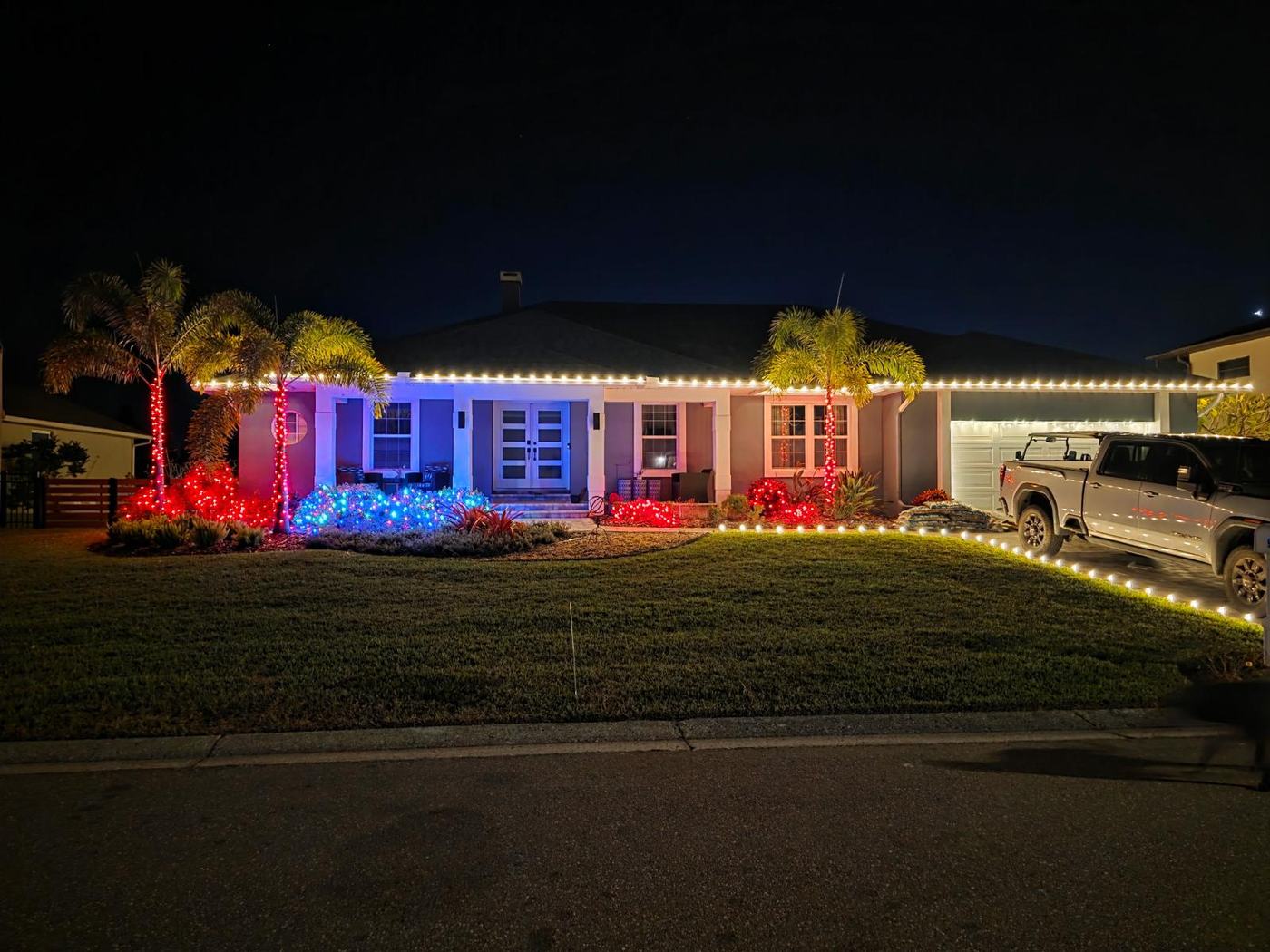 Warm white roofline with wrapped palms and coloured landscape accents